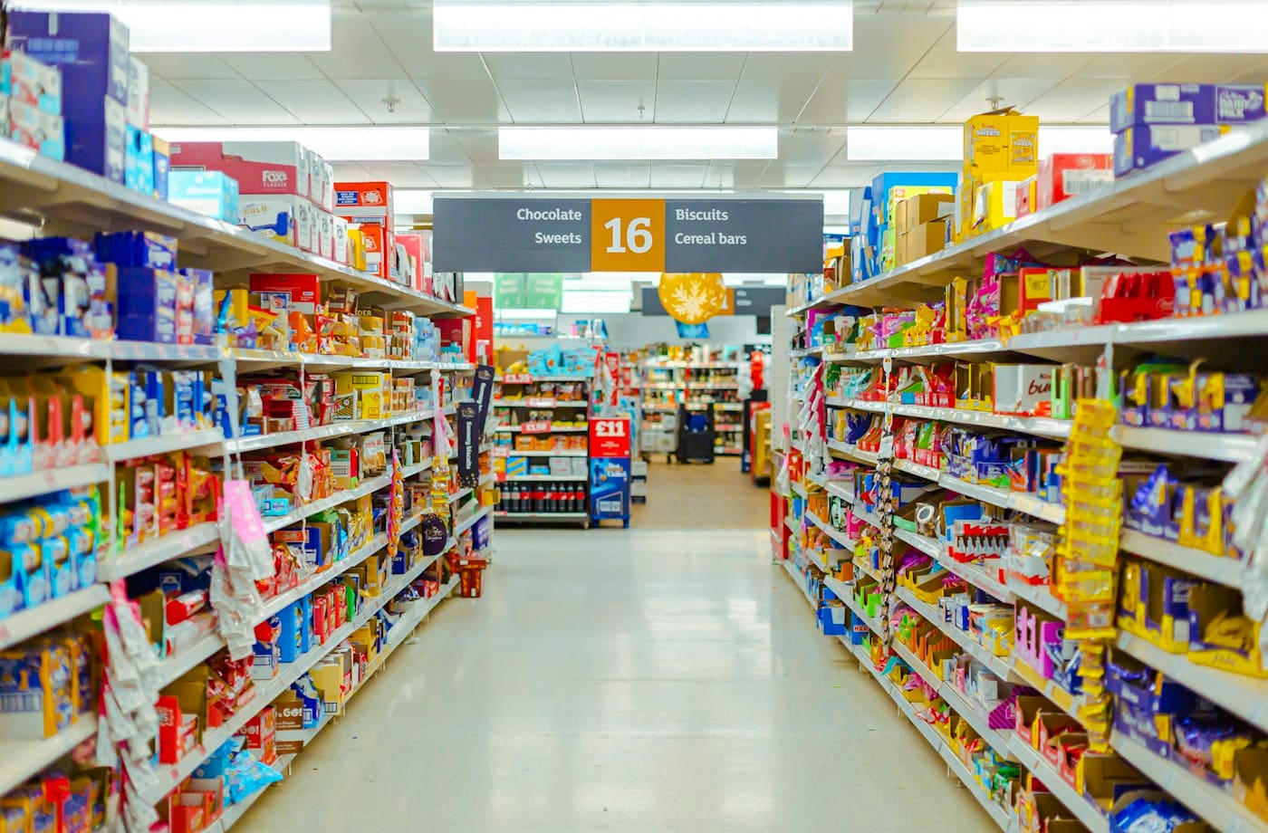 A supermarket aisle with fully stocked shelves